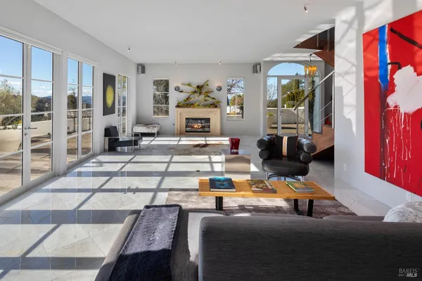 a living room with furniture flowerpot and wooden floor