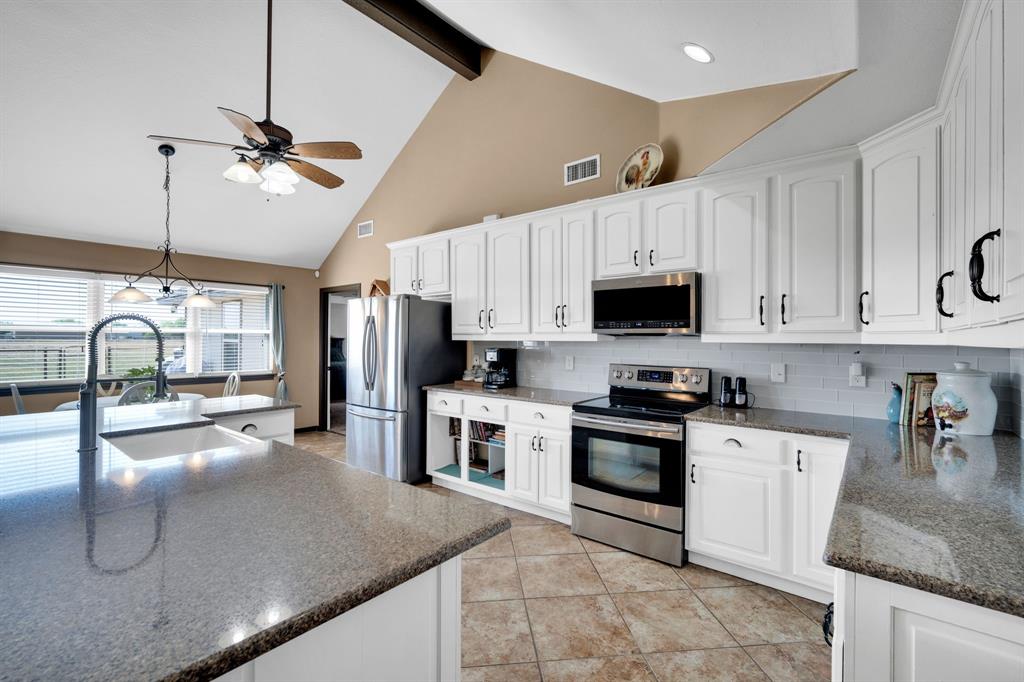 130 Eubanks Road Maypearl, TX 76064 - Photo 22 of 39 a kitchen with granite countertop a sink stainless steel appliances and cabinets
