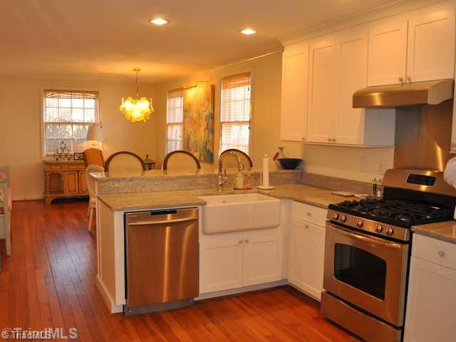 1611 Independence Road Greensboro, NC 27408 - Photo 3 of 14 Kitchen. BRAND NEW kitchen with stainless steel appliances-- refrigerator, dishwasher, gas range and hood. Undermount farmhouse sink, custom cabinets, granite counters, and canned lighting.