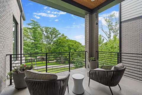 a living room with furniture potted plant and a large window
