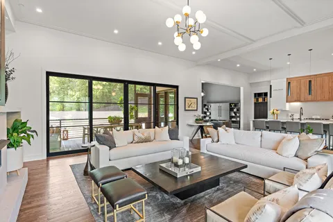 a dining room with furniture water view and a floor to ceiling window