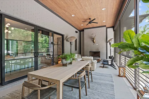 a living room with patio fireplace furniture and a potted plant