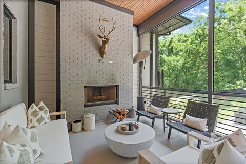 a view of a patio with table and chairs potted plants with wooden floor and fence