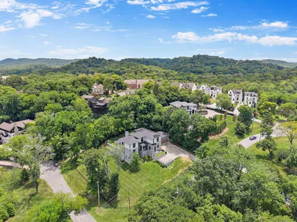 a front view of a house with a garden and plants