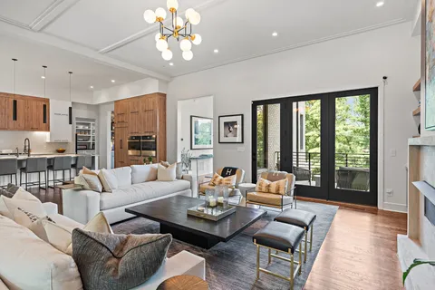 a living room with furniture and large windows