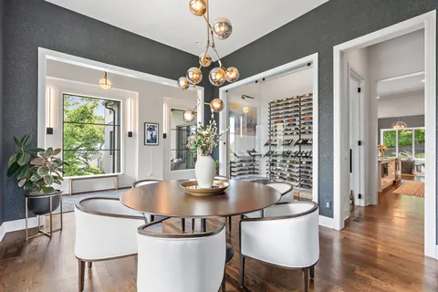 a view of a dining room with furniture wooden floor and chandelier