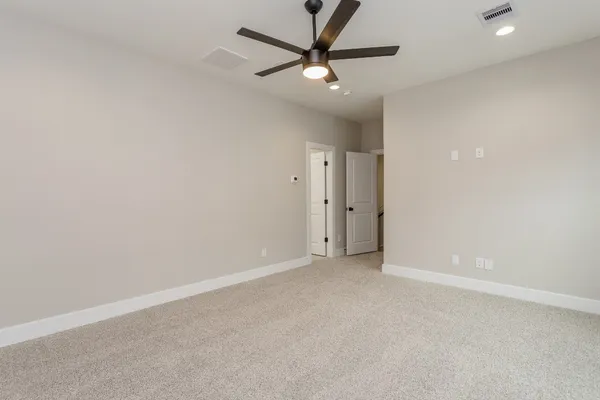 an empty room with a ceiling fan and a ceiling fan