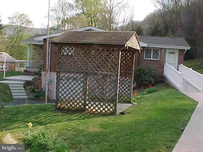 22118 Seldom Seen Road Southwest Lonaconing, MD 21539 - Photo 2 of 15 a front view of a house with a garden
