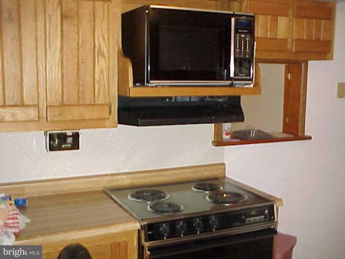 22118 Seldom Seen Road Southwest Lonaconing, MD 21539 - Photo 4 of 15 a stove top oven sitting inside of a kitchen