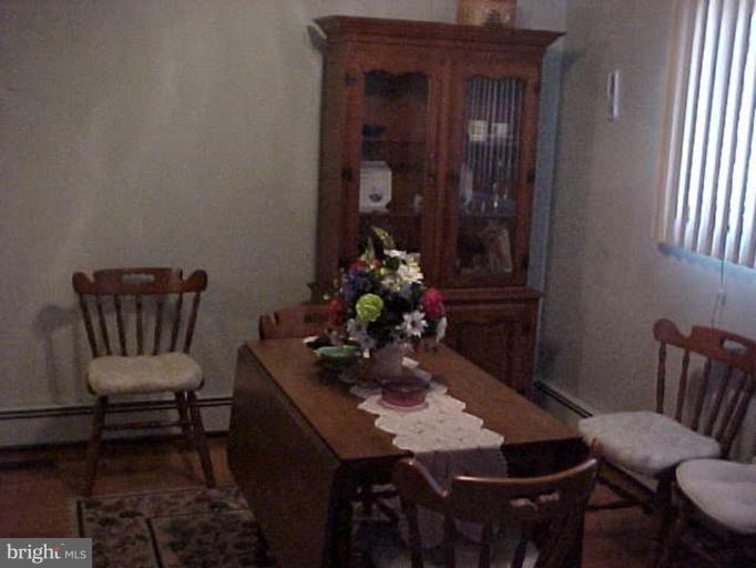 22118 Seldom Seen Road Southwest Lonaconing, MD 21539 - Photo 8 of 15 a view of a dining room with furniture and wooden floor