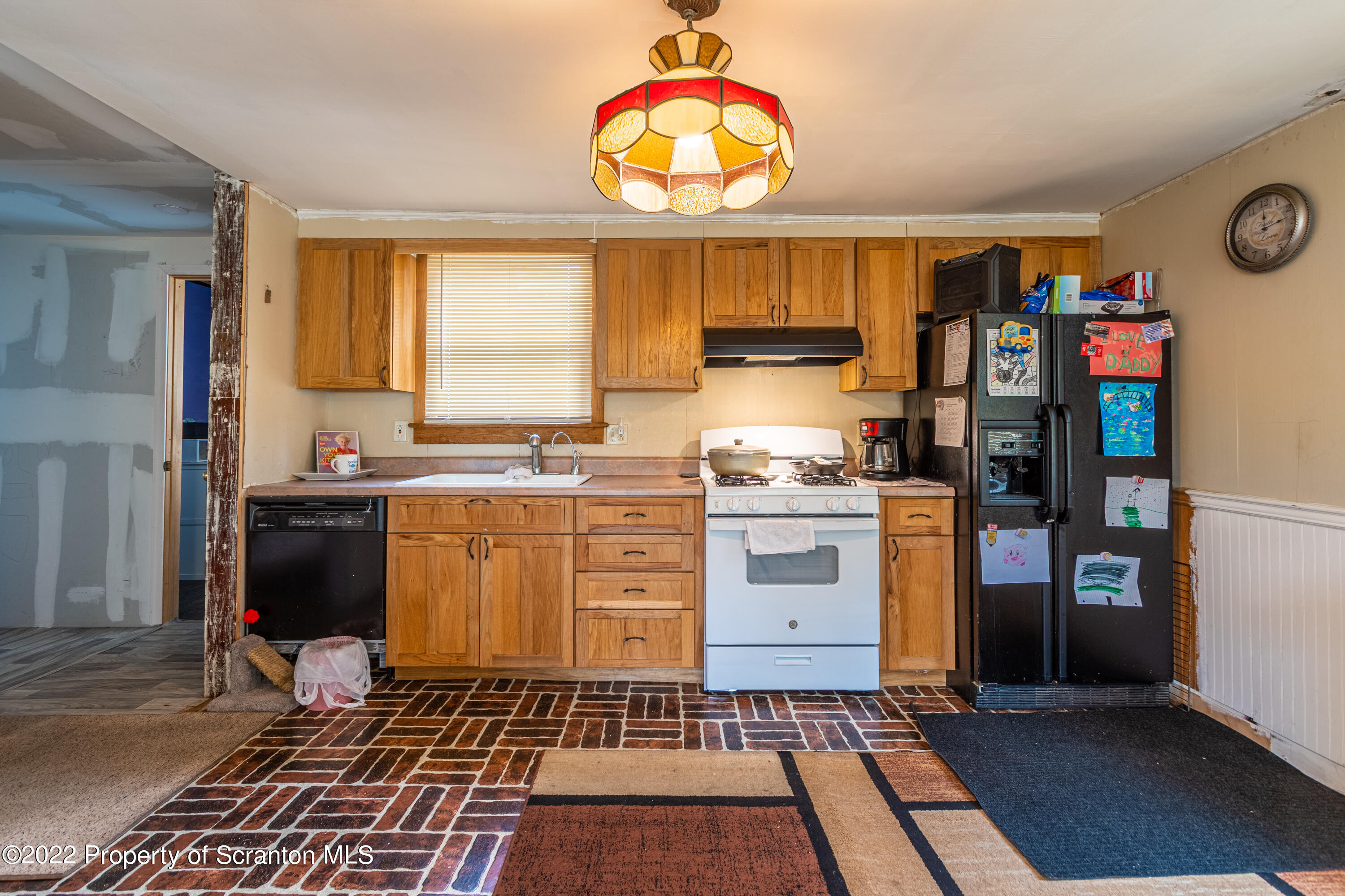 184 Crescent Lake Road Scotrun, PA 18355 - Photo 15 of 38 a kitchen with granite countertop a stove a refrigerator and a window
