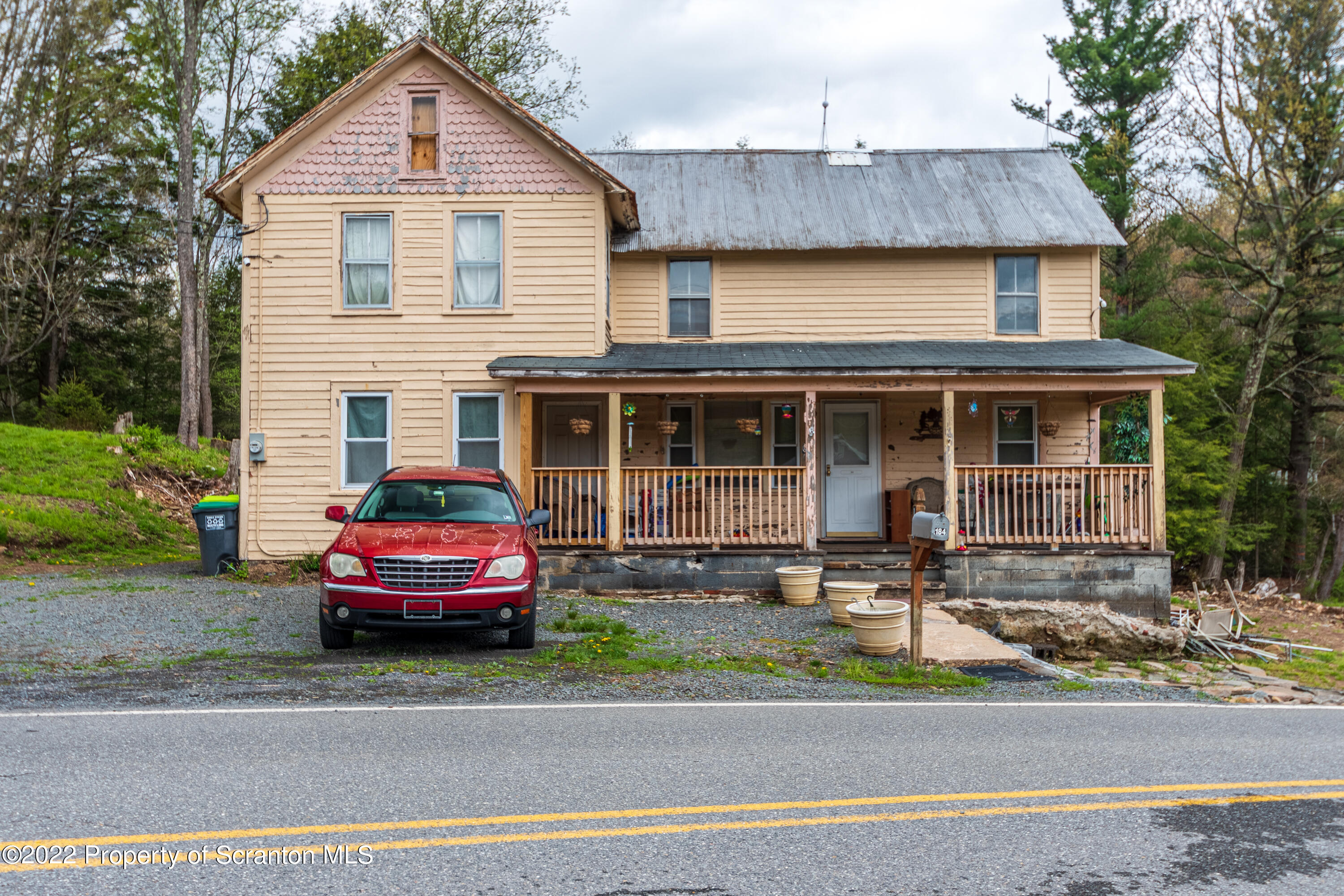 184 Crescent Lake Road Scotrun, PA 18355 - Photo 2 of 38 a front view of a house with a yard and a garage