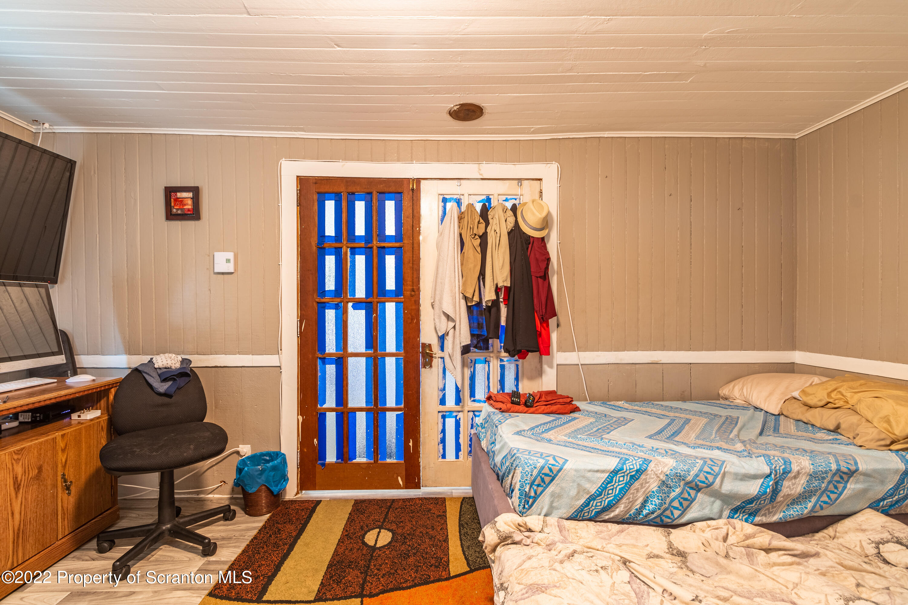 184 Crescent Lake Road Scotrun, PA 18355 - Photo 22 of 38 a bedroom with a bed and a flat screen tv