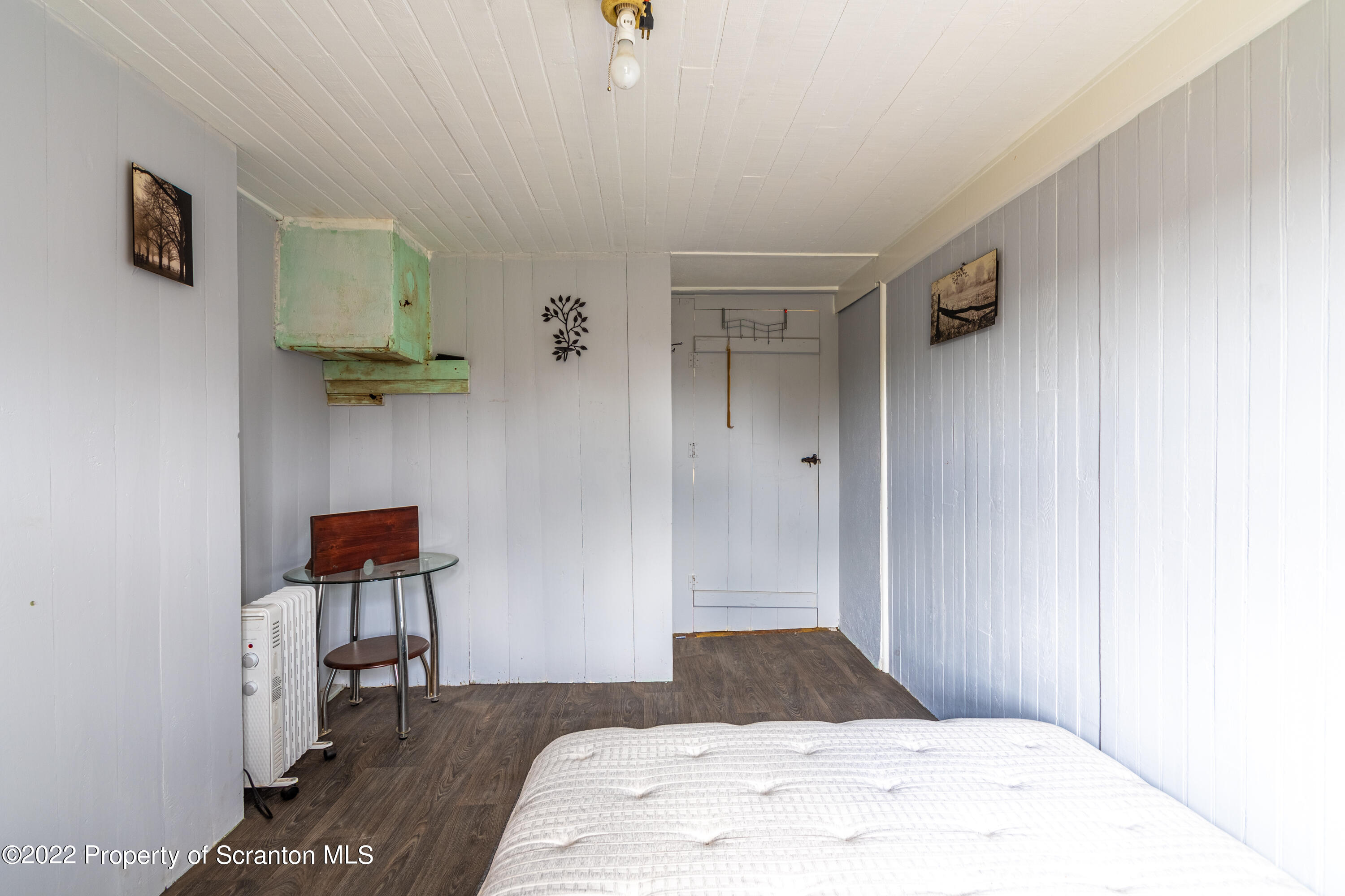 184 Crescent Lake Road Scotrun, PA 18355 - Photo 24 of 38 a bedroom with a bed and a lamp on desk