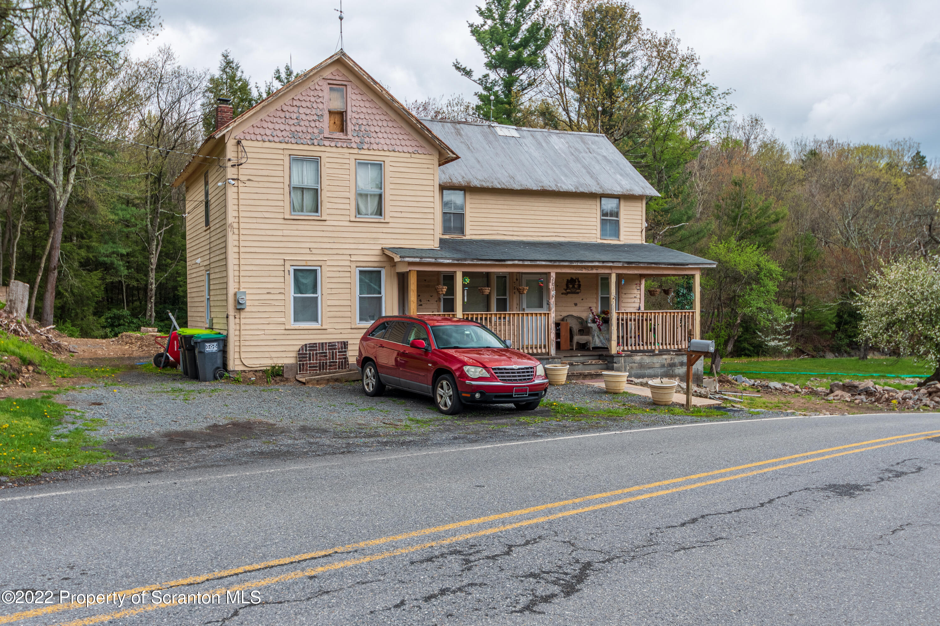 184 Crescent Lake Road Scotrun, PA 18355 - Photo 3 of 38 a front view of a house with a garden and parking