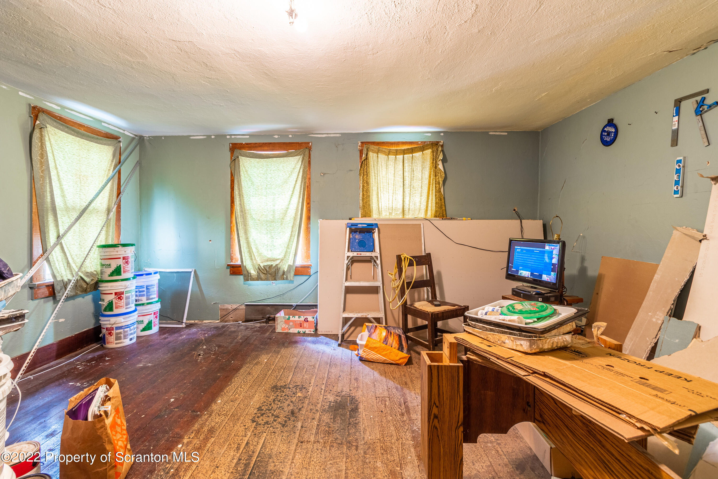 184 Crescent Lake Road Scotrun, PA 18355 - Photo 31 of 38 a bedroom with a bed and a computer on a desk next to a window