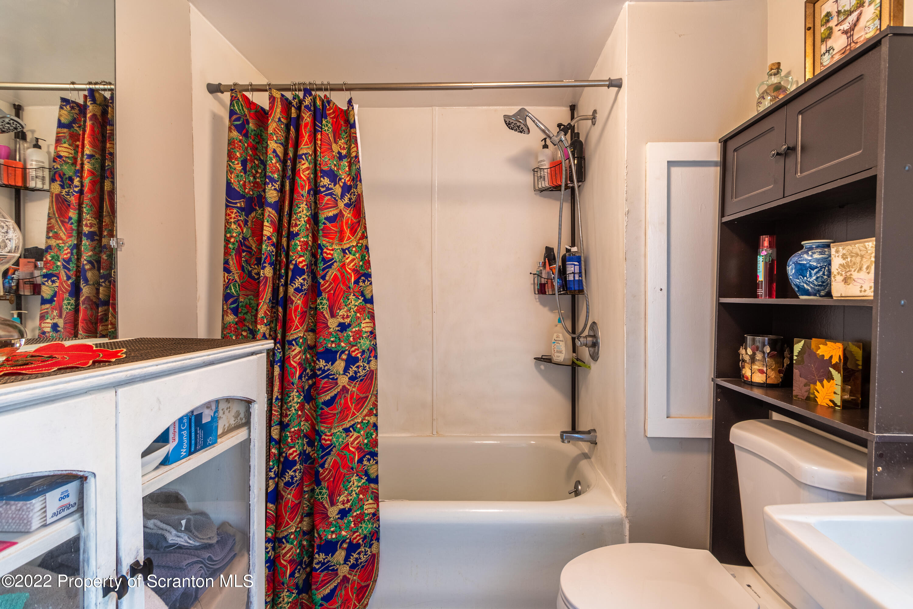 184 Crescent Lake Road Scotrun, PA 18355 - Photo 37 of 38 a bathroom with a toilet and a shower curtain