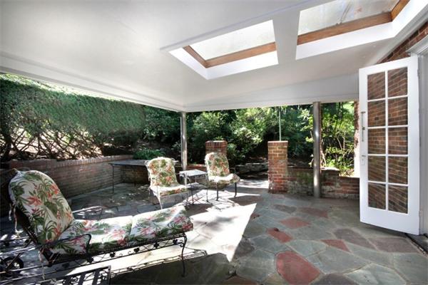 16 Gate House Road Newton, MA 02467 - Photo 13 of 20 a living room with patio furniture and floor to ceiling windows