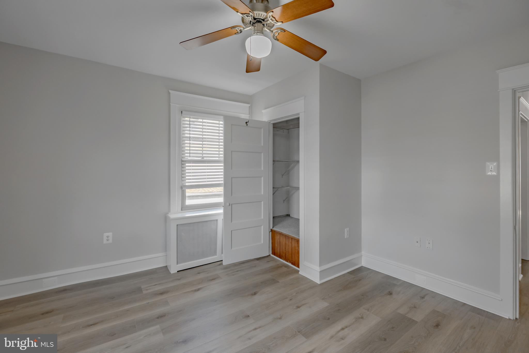 1210 West Darby Road Havertown, PA 19083 - Photo 12 of 33 an empty room with wooden floor chandelier fan and windows