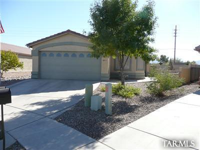 8421 Red Rock Ridge Court Tucson, AZ 85742 - Photo 1 of 16 a front view of a house with garden