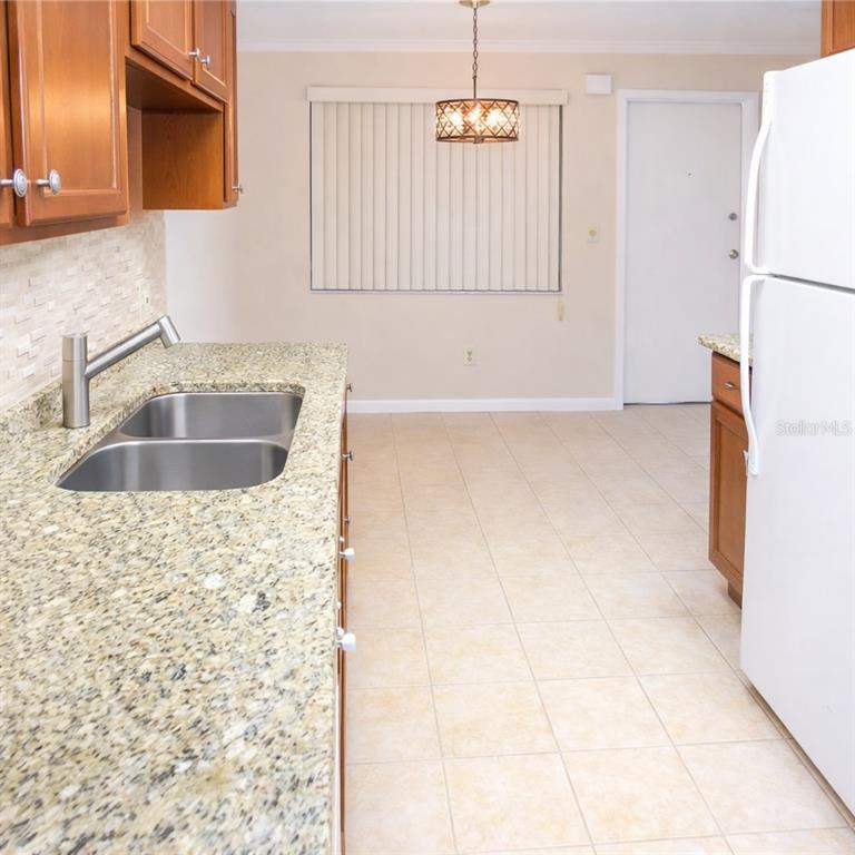 5273 Vineland Road, Unit 103 Orlando, FL 32811 - Photo 5 of 8 a bathroom with a sink a toilet and mirror