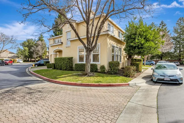 a view of a street with a car parked in front of it