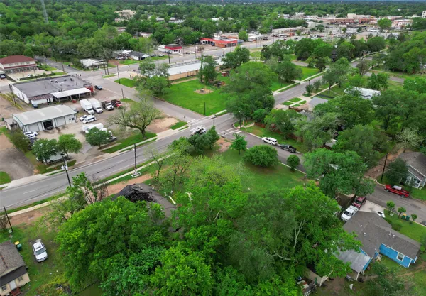 an aerial view of residential houses with outdoor space and street view