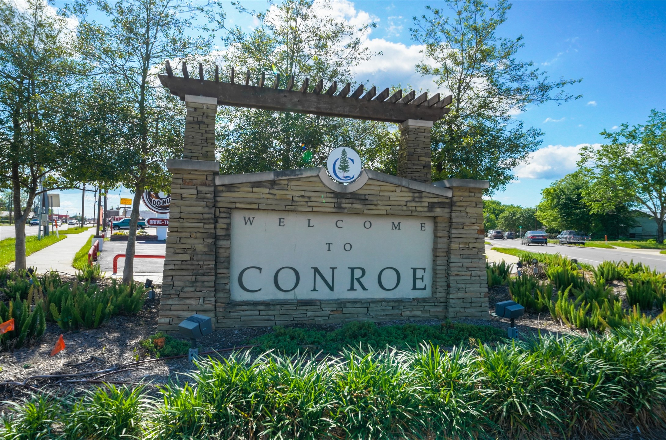 406 East Phillips Street Conroe, TX 77301 - Photo 3 of 20 a view of outdoor space with sign board and garden