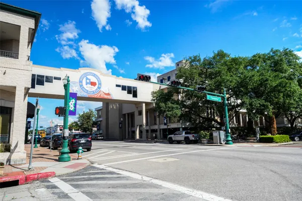 a view of street along with retail shop and buildings