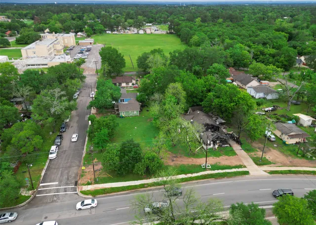 an aerial view of residential houses with outdoor space and street view