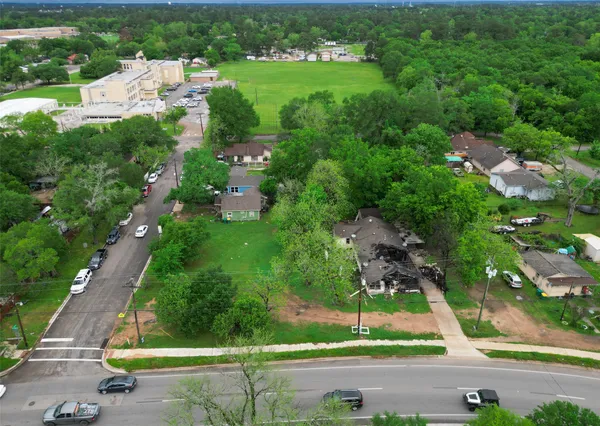 an aerial view of residential houses with outdoor space and street view