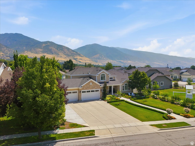 1257 Rigby Road Kaysville, UT 84037 - Photo 51 of 55 Two-story residence featuring a stone and stucco exterior, a two-car garage, and a concrete driveway