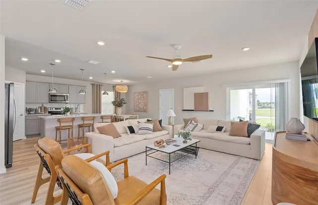 a living room with furniture and kitchen view