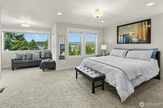 a spacious bedroom with a bed and a couch