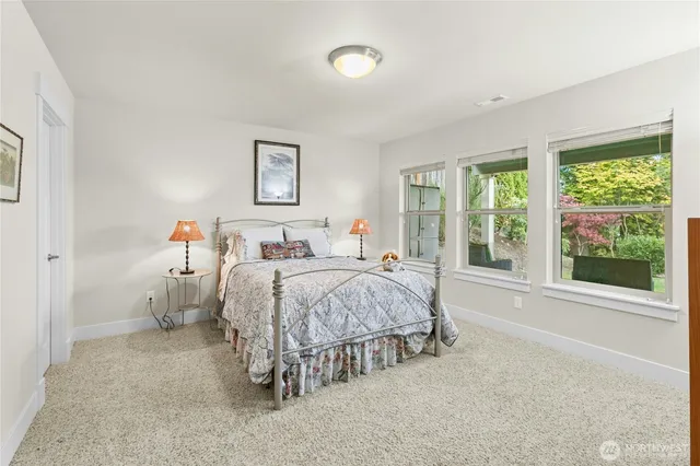 a bedroom with a bed and a large window