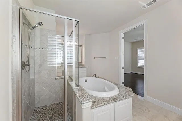 a bathroom with a granite countertop sink mirror and shower