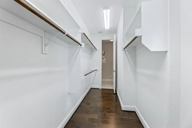a view of a hallway with wooden floor and entryway