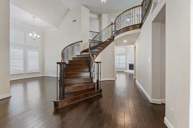 a view of hallway with stairs and wooden floor