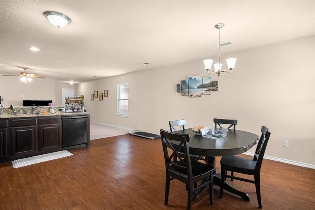 a view of a dining room with furniture wooden floor and chandelier