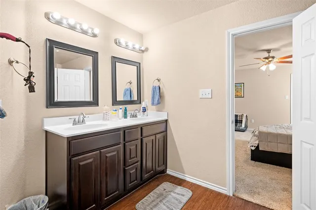 a en suite bathroom with a double vanity sink and a mirror