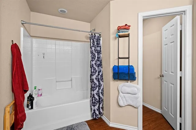 a bathroom with a shower a toilet and a shower