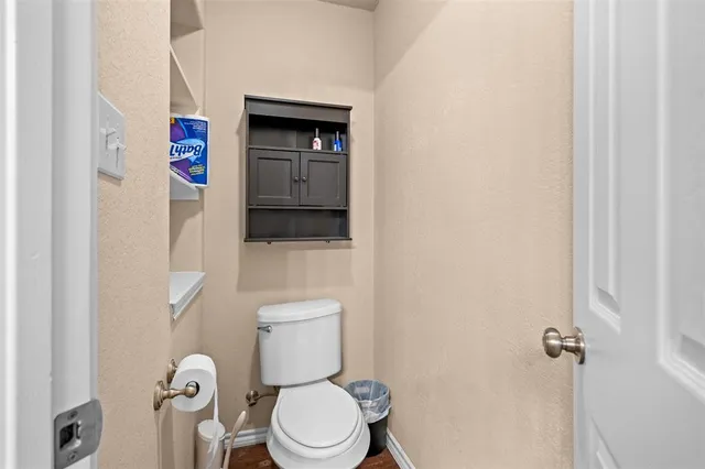a white toilet sitting next to a bathroom sink