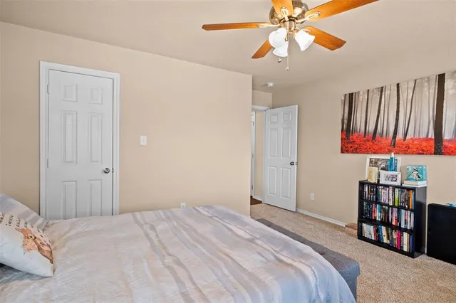 a bedroom with a bed and a book shelf