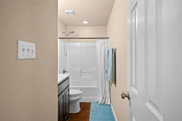 a bathroom with a shower and a toilet