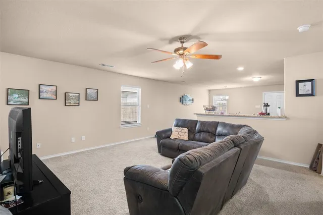 a living room with furniture and kitchen view