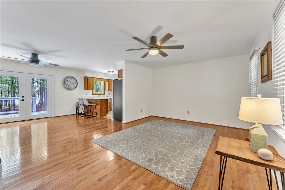 4416 Denver Cove Road Anderson, SC 29625 - Photo 6 of 31 Hardwood floors and dual ceiling fans enhance this open-concept living space with outdoor deck access.