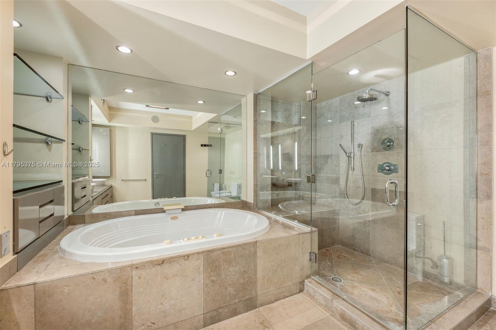 450 Alton Road, Unit 2303 Miami Beach, FL 33139 - Photo 12 of 51 a bathroom with a bathtub and shower