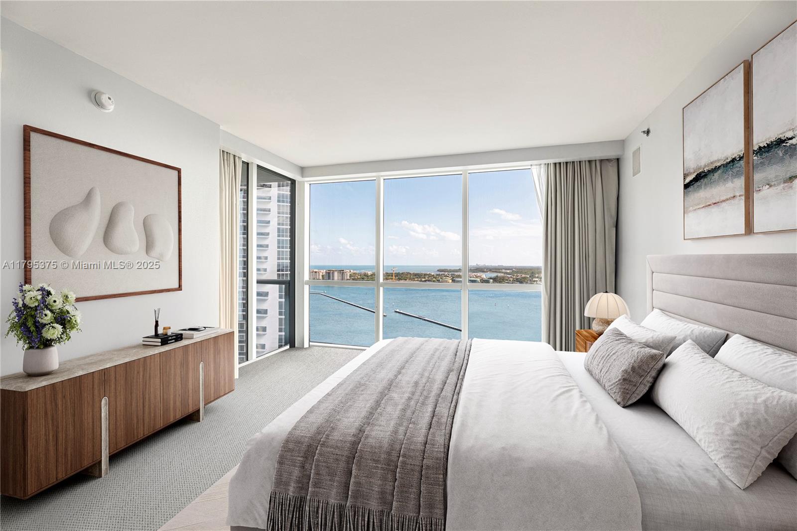 450 Alton Road, Unit 2303 Miami Beach, FL 33139 - Photo 14 of 51 a bedroom with a large bed and a chandelier