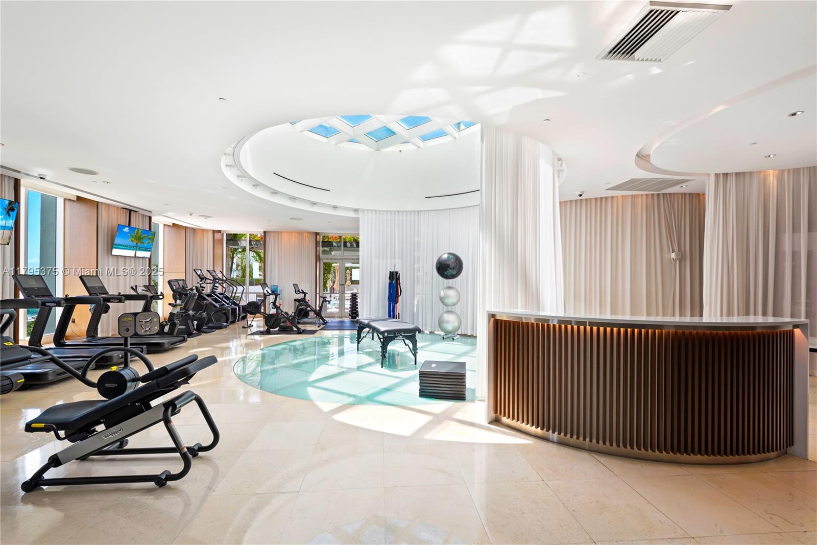 450 Alton Road, Unit 2303 Miami Beach, FL 33139 - Photo 28 of 51 a view of a livingroom with furniture and gym equipment