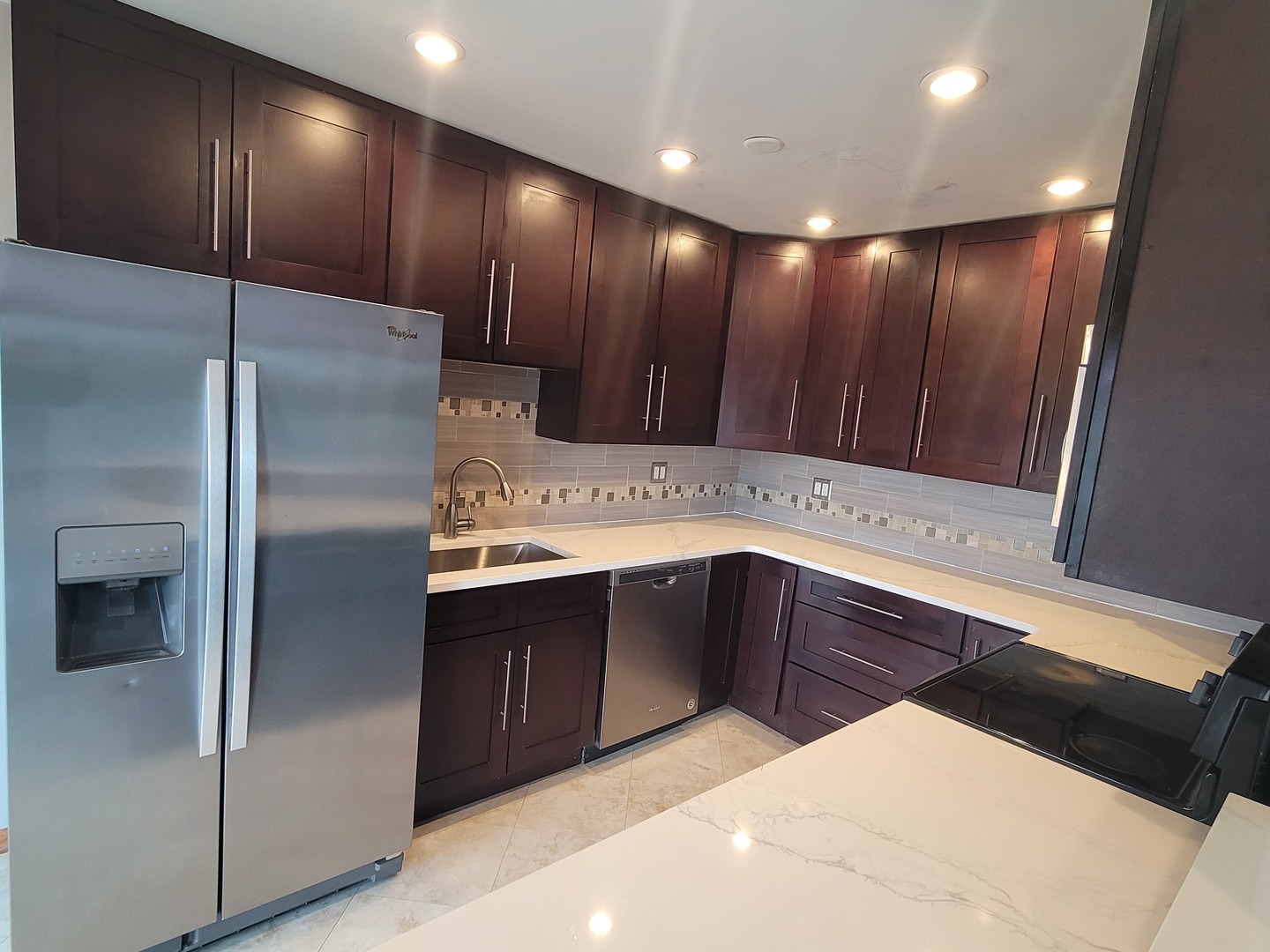 725 West Huntington Commons Road, Unit 208 Mount Prospect, IL 60056 - Photo 8 of 21 a kitchen with wooden cabinets and stainless steel appliances